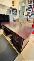 Full view of desk showing top, pedestals and surrounding items