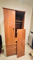 Full view of cabinet with upper door partially open showing shelf and lock