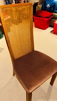 Front view of dining chair showing cane back and upholstered seat