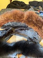 Assorted faux-fur collars on surface