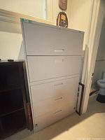 Front view showing four drawers, recessed handles, lock