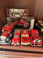 Shelf with six loose die-cast fire vehicles and one boxed model