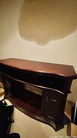 Front view of dark brown wooden fireplace mantel