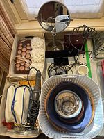 Overall lot: storage bins, mirror, jewelry stands, fan, hair accessories visible
