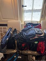 Pile of assorted bags on chairs