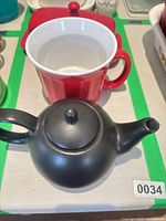 black teapot and red mug together