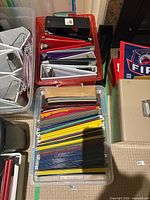 Two totes containing binders and hanging folders