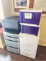 All four organizers lined up: metal file cabinet, plastic drawer tower, grey 2-drawer unit, white frame with purple drawers