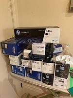 Overall stack of boxed HP and Brother toner cartridges
