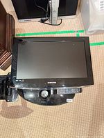 Top view of Samsung 22" LCD TV with remote and base visible