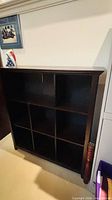Front view of dark brown 8-cube shelving unit