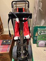 Front view of Bag Boy golf push cart, red bag trolley, nested metal carts