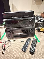 Stacked view of Adcom GFS-6 selector, Sony receiver, Denon receiver, two remotes and cables