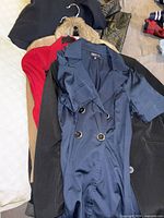 Stack of six jackets and sweaters showing variety of colors and styles