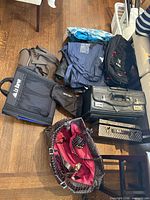 Group shot of assorted travel bags on floor