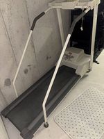 Full view of treadmill showing frame, belt and handrails