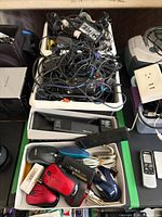 Overview of trays with bundled cables, mice box and electronic devices