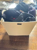 All hats inside white storage bin