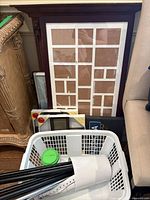 Group of frames including 20-opening collage and packaged collage frame with basket foreground