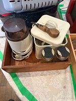 Tray containing grinder, enamel canisters, stainless shakers, screwdriver