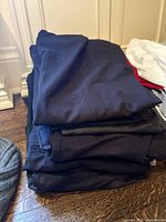 Stack of folded dark-coloured pants