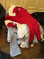 Pile of assorted shirts on floor