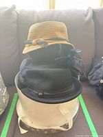 Stacked hats in white hat box