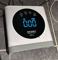 Top view of Nailgirls SUN LED UV nail lamp showing control panel and timer display