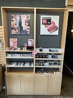 Front view of both light maple display cabinets with acrylic shelving and lower storage doors