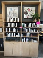 Full view of both light maple shelving cabinets with products shown for scale