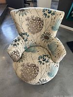 Front view of floral botanical swivel accent chair