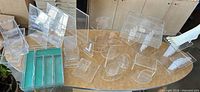 Wide shot of assorted clear acrylic display pieces and green liners on table
