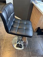 Front angled view showing seat tufting and chrome base