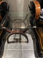 Square end table, clear glass top on curved wood base