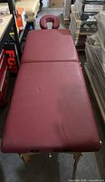 Top view of burgundy foldable massage table surface