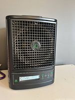 Angled front view of the iQ Pure Air 3000 air purifier showing grille and overall condition