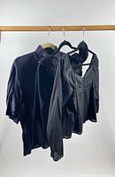Three tops on hangers front view