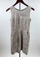 Full front view of ashy gray leather dress on hanger