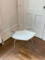 Front angle of wire chair showing frame and seat pad