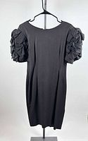 Front view of black linen dress on hanger displaying puff sleeves and overall condition