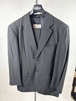Front view of jacket showing lapel, buttons, pockets, brand tag