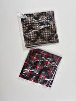 Both scarves in original plastic sleeves