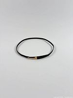 Full view of black leather belt laid flat showing overall length