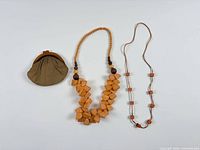 All three items side by side: coin purse, bead necklace, cube bead necklace