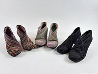 Three pairs of United Nude Fold booties arranged side by side