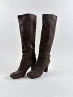 Full view of pair of tall brown Prada boots standing side by side