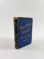 Front cover showing blue cloth binding with gilt title