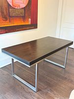 Full view of rectangular table showing wood top and steel legs