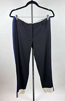 Front view of black trousers with blue side stripe and cream hem