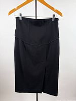 Front view of black pencil skirt on hanger